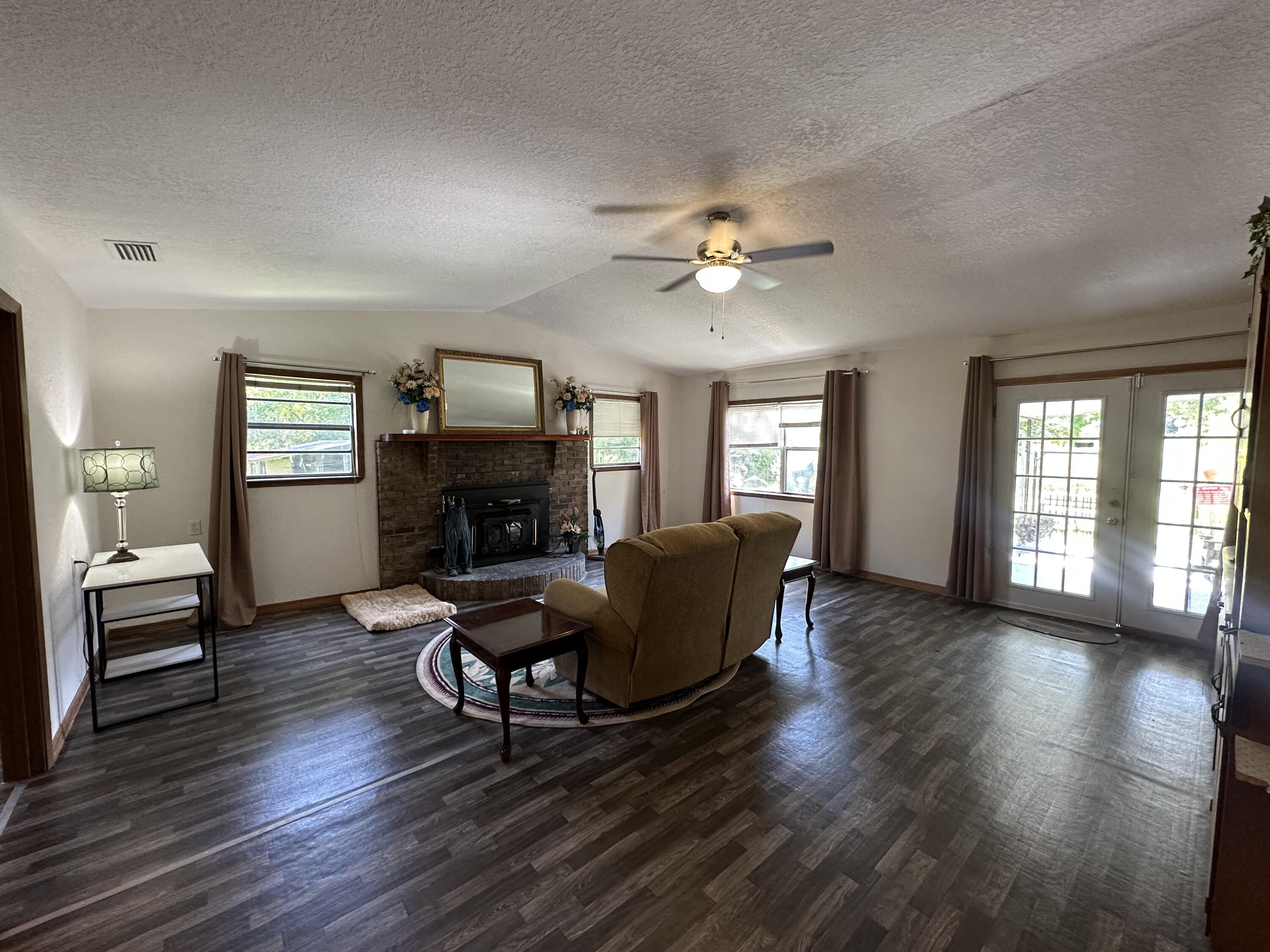 1875 Hathaway Johnson Road Baker, FL 32531 - Photo 3 of 40 a living room with furniture and a fireplace