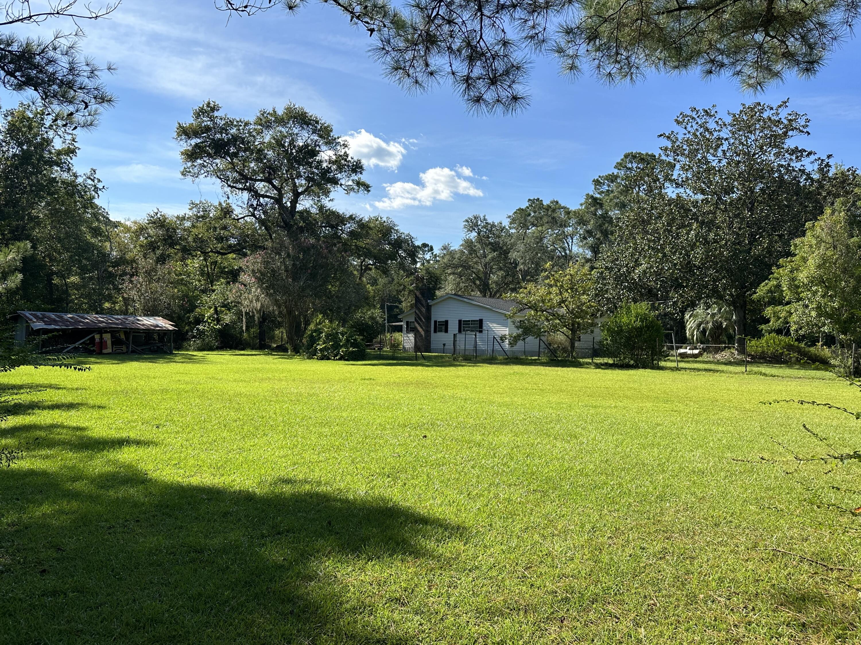 1875 Hathaway Johnson Road Baker, FL 32531 - Photo 31 of 40 a view of a field of grass and trees