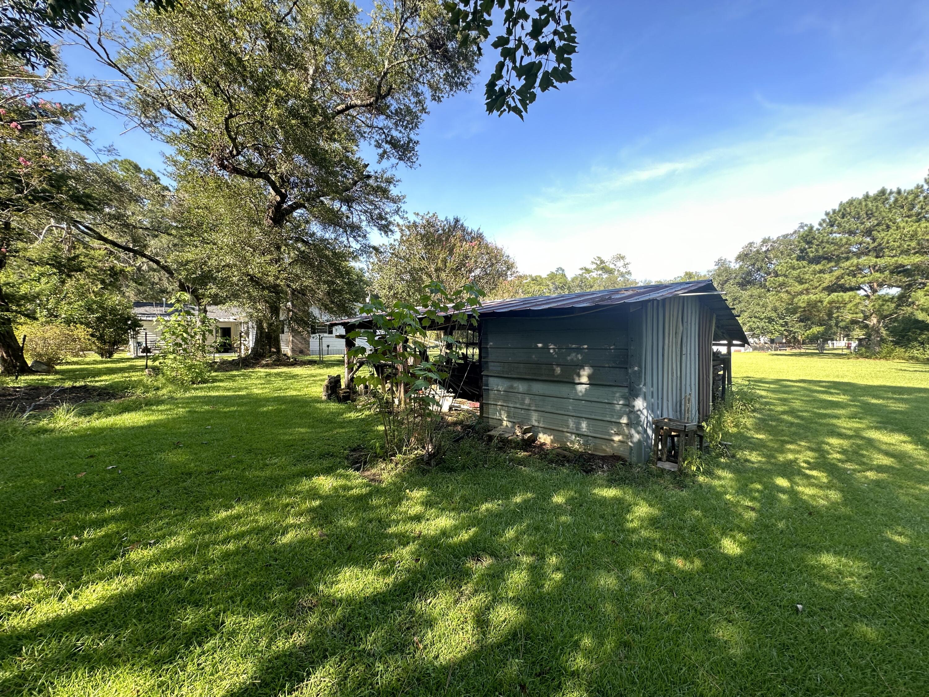 1875 Hathaway Johnson Road Baker, FL 32531 - Photo 4 of 40 a view of a tiny house with yard and a tree