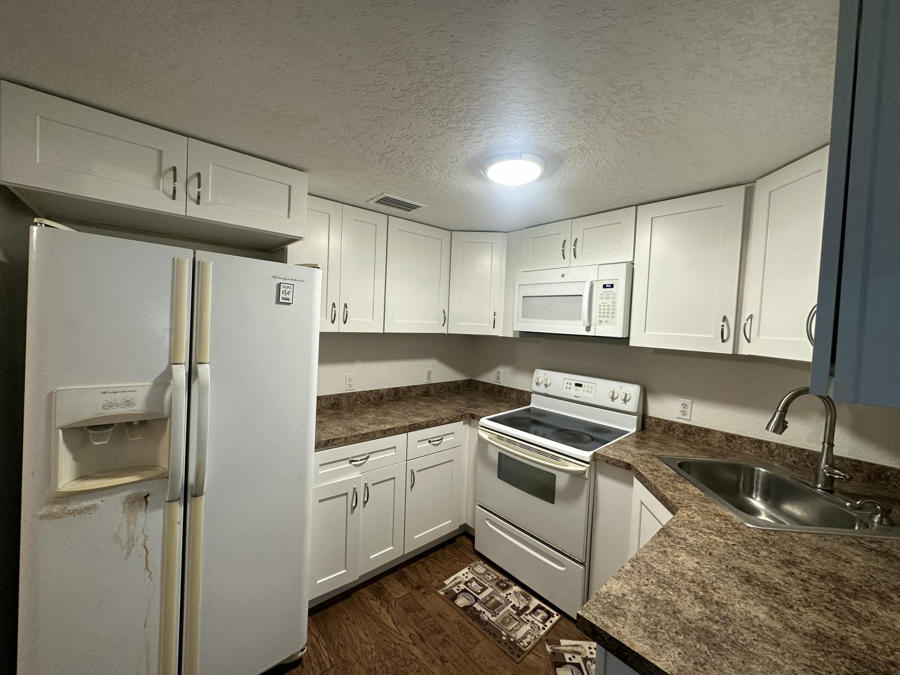 1875 Hathaway Johnson Road Baker, FL 32531 - Photo 5 of 40 a kitchen with a refrigerator sink and cabinets