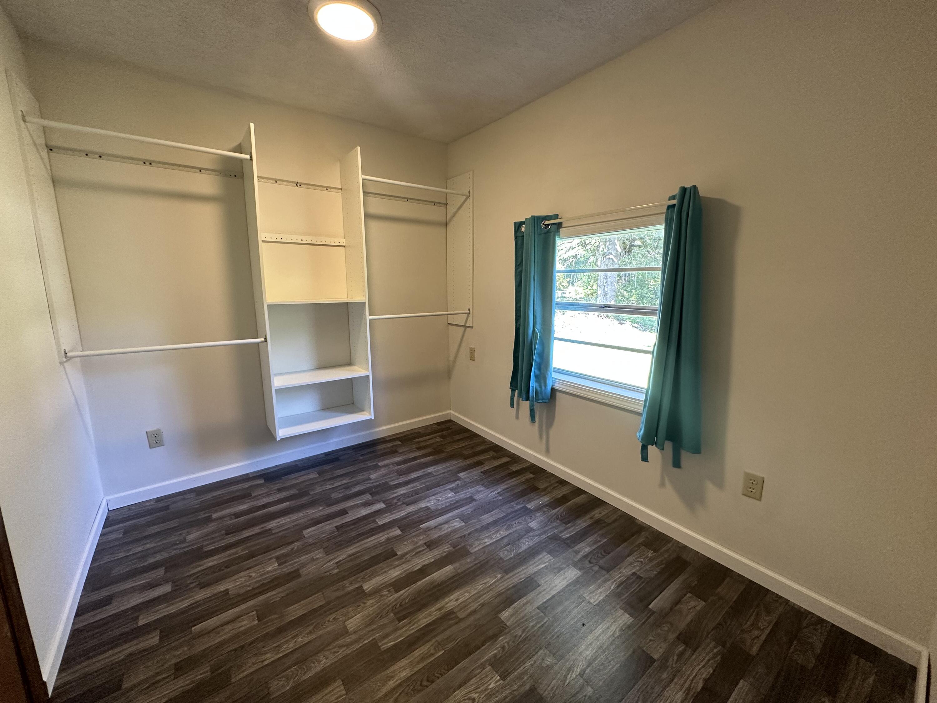 1875 Hathaway Johnson Road Baker, FL 32531 - Photo 8 of 40 a room with wooden floor and a window