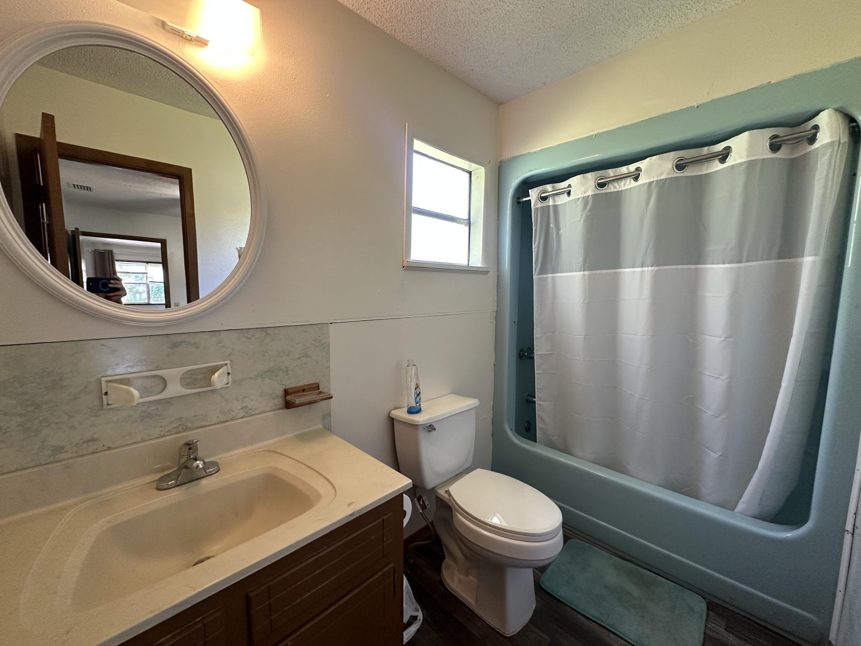 1875 Hathaway Johnson Road Baker, FL 32531 - Photo 9 of 40 a bathroom with a sink a toilet a mirror and shower