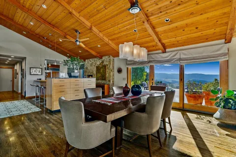 a view of a dining room with furniture window and wooden floor