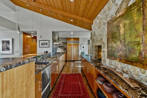 a kitchen with stainless steel appliances granite countertop a sink and a counter space