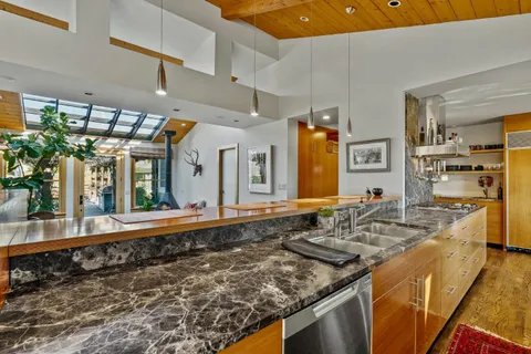 a view of an empty room with a fireplace and a window