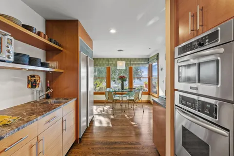 a living room with lots of furniture and kitchen view