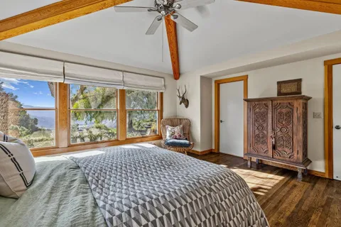 a bathroom with a granite countertop sink a mirror and shower