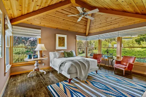 a bathroom with a granite countertop sink a large mirror and a bathtub