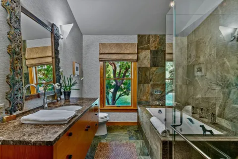 a bedroom with a bed and large window