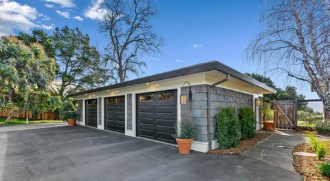 a view of a house with backyard sitting area and garden