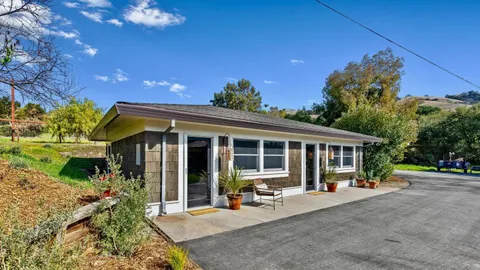 an aerial view of a house with a yard