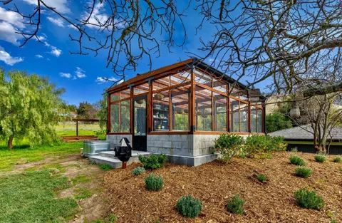 a view of porch with a table and chairs