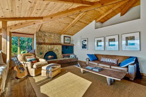 a living room with furniture a fireplace and a table