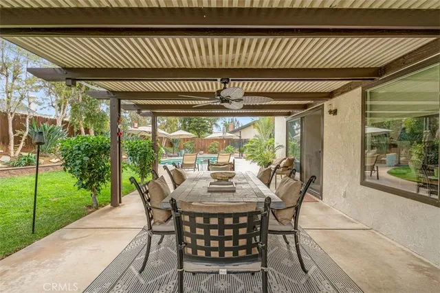 a view of a house with backyard and sitting area