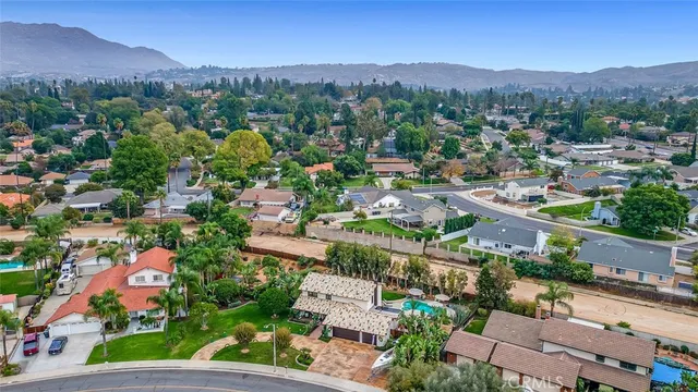 an aerial view of residential houses with outdoor space and garden