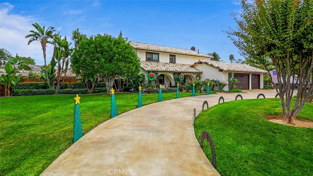5056 Windhill Drive Riverside, CA 92507 - Photo 3 of 66 a view of a white house with a big yard and potted plants