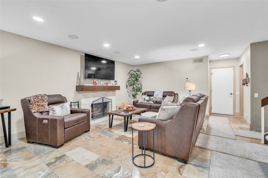 5056 Windhill Drive Riverside, CA 92507 - Photo 39 of 66 a living room with furniture a flat screen tv and a refrigerator