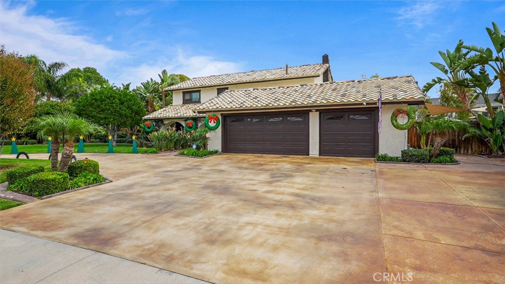 5056 Windhill Drive Riverside, CA 92507 - Photo 4 of 66 a front view of a house with a yard and garage