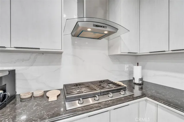 a bathroom with a granite countertop sink a toilet and a mirror