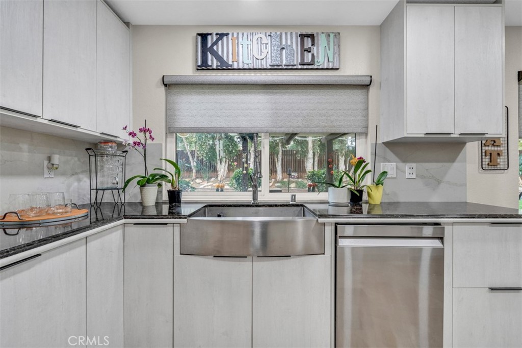 5056 Windhill Drive Riverside, CA 92507 - Photo 47 of 66 a kitchen with stainless steel appliances a sink and cabinets