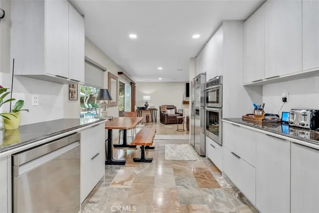 a dining table with chairs and window