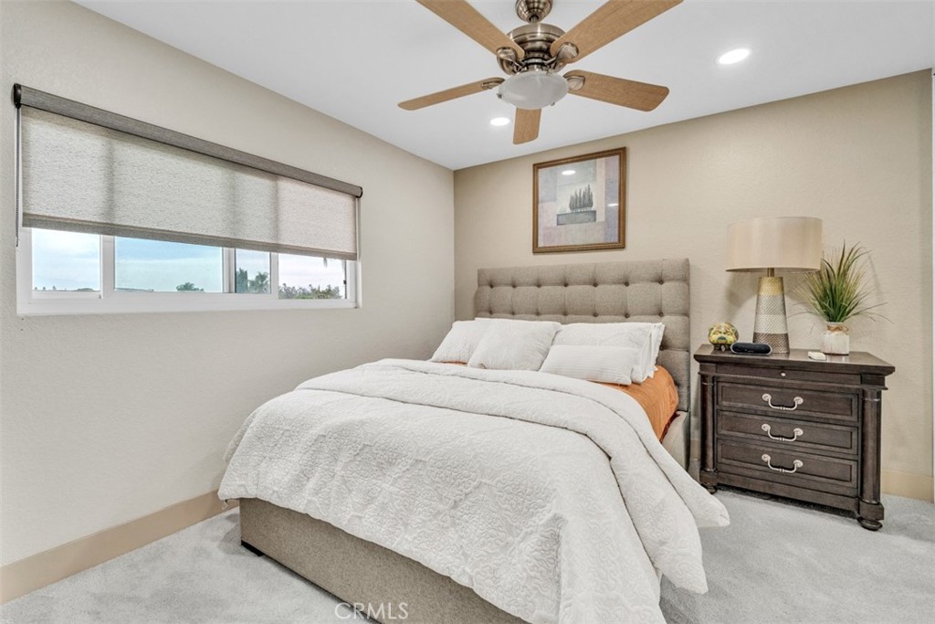 5056 Windhill Drive Riverside, CA 92507 - Photo 54 of 66 a bedroom with a bed a window and painting on the wall