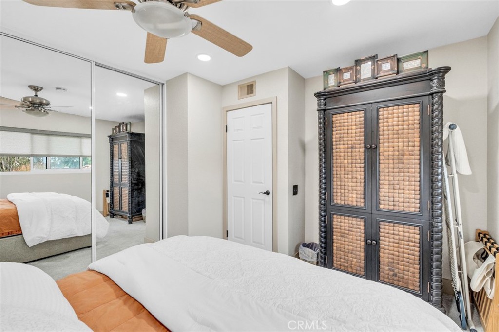 5056 Windhill Drive Riverside, CA 92507 - Photo 55 of 66 a bedroom with a large bed and a chandelier