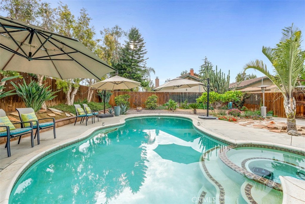 5056 Windhill Drive Riverside, CA 92507 - Photo 8 of 66 a view of a swimming pool with a patio and a garden