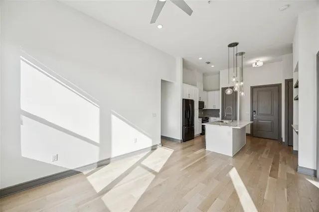 a large kitchen with a refrigerator a sink and a stove