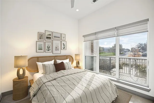 a bedroom with a large bed and a night stand