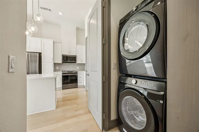 a view of a hallway with washer and dryer