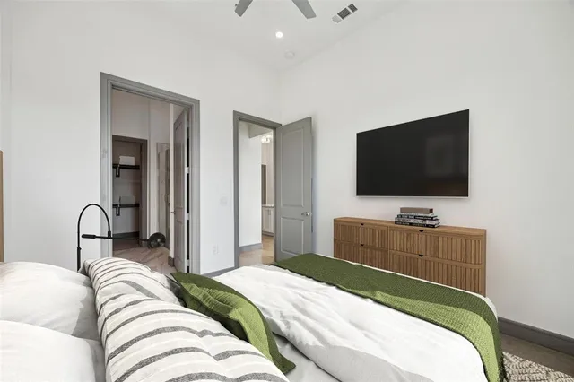 a bedroom with a bed and a flat screen tv