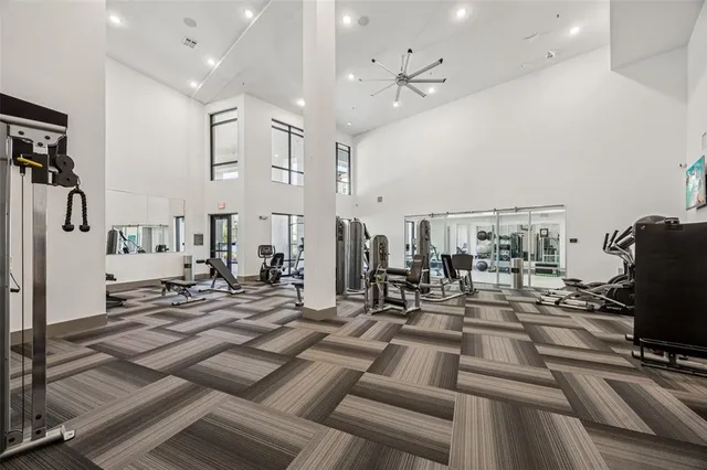 a view of a room with lots of gym equipment
