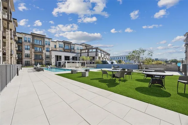 a swimming pool with outdoor seating and yard