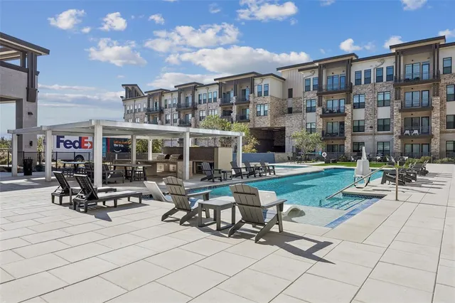 a view of a building with sitting area and garden