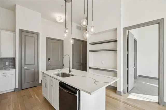 a kitchen with a sink and refrigerator