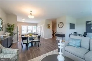 a living room with furniture dining table and a large window