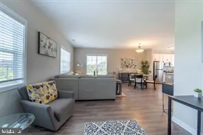 a living room with furniture and a dining table with rug