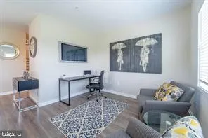 a living room with furniture and a dining table with rug