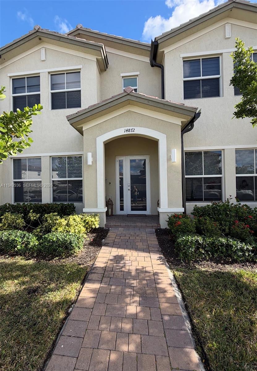 a front view of a house with garden