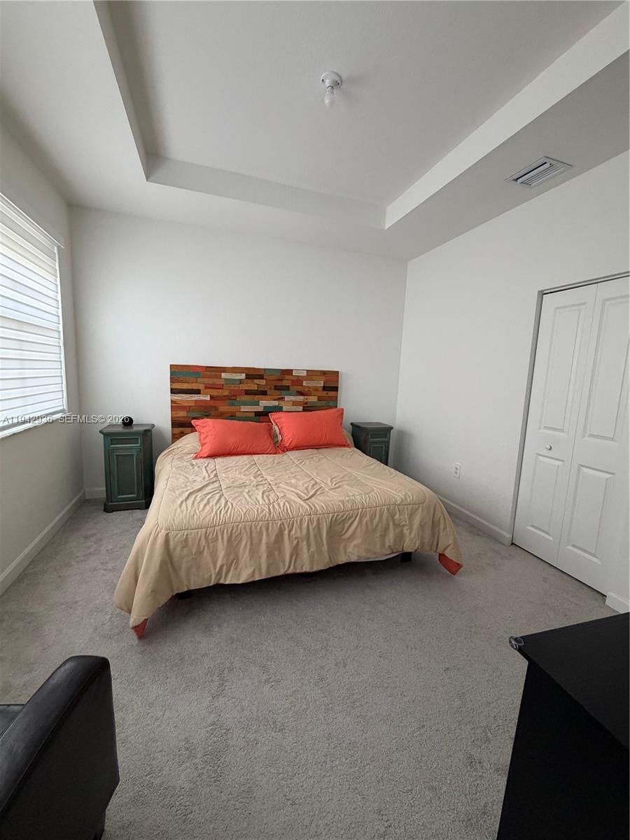 14872 Southwest 265th Street Homestead, FL 33032 - Photo 11 of 15 a bedroom with a bed and window