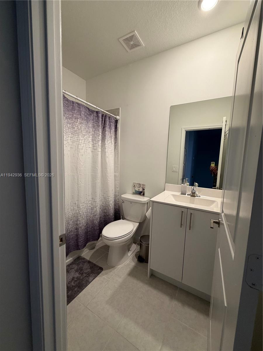14872 Southwest 265th Street Homestead, FL 33032 - Photo 15 of 15 a bathroom with a toilet sink and mirror