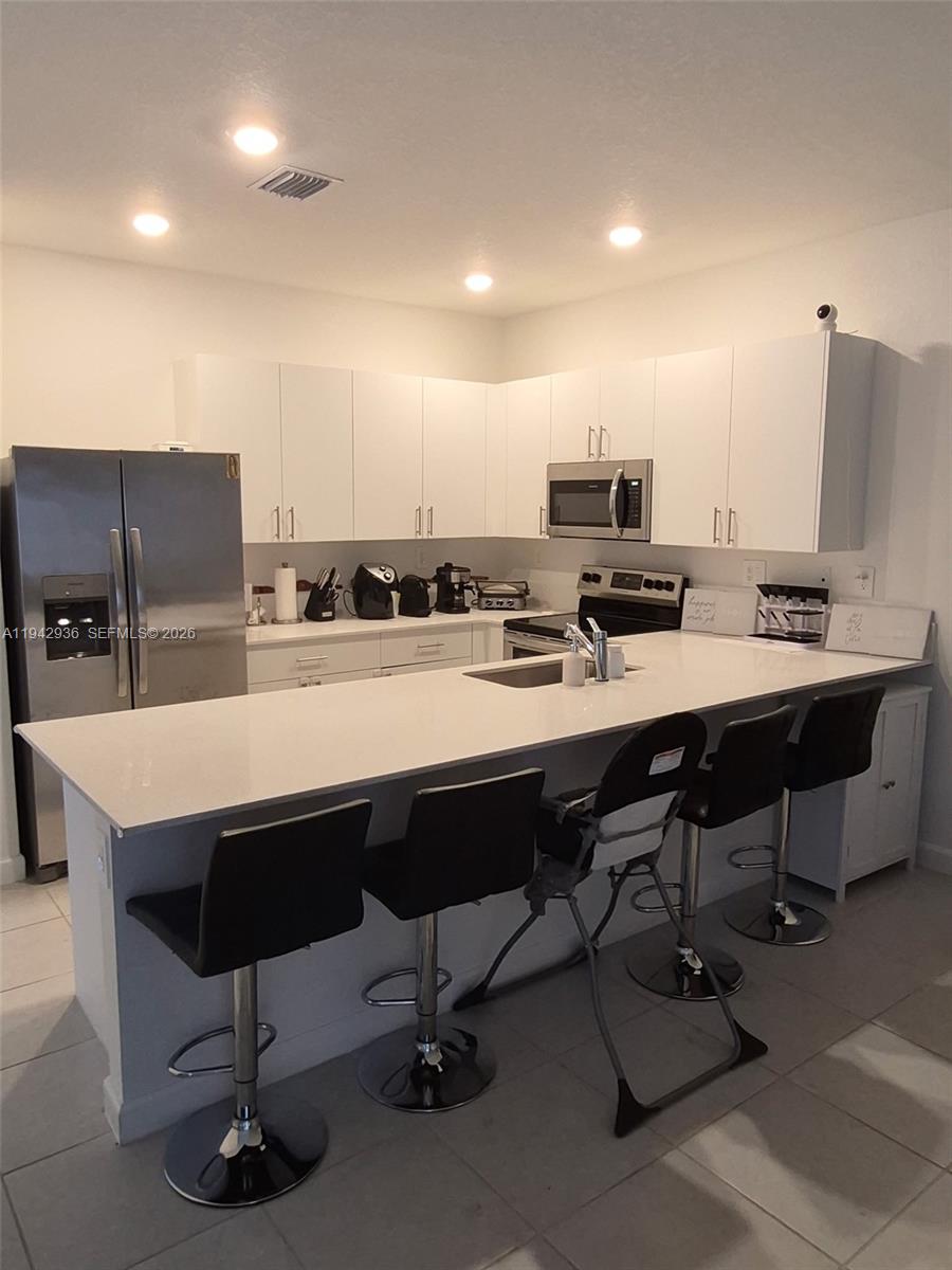 14872 Southwest 265th Street Homestead, FL 33032 - Photo 5 of 15 a kitchen with a sink cabinets and counter space
