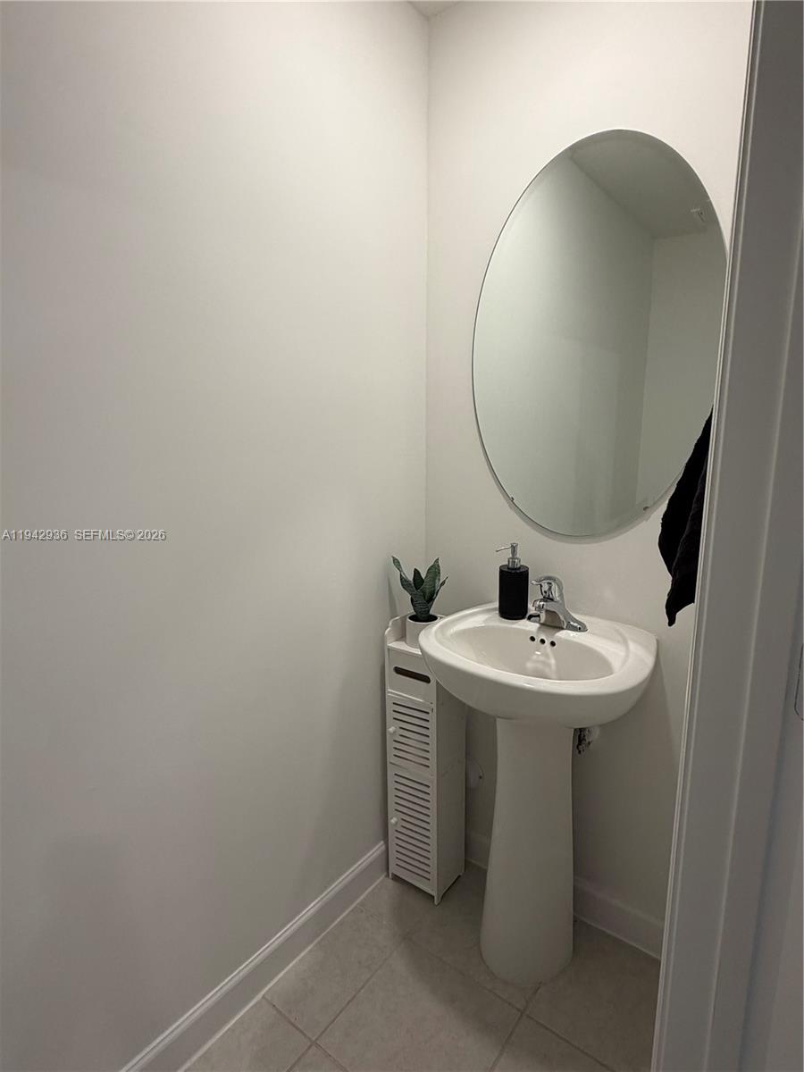 14872 Southwest 265th Street Homestead, FL 33032 - Photo 10 of 15 a bathroom with a sink and mirror