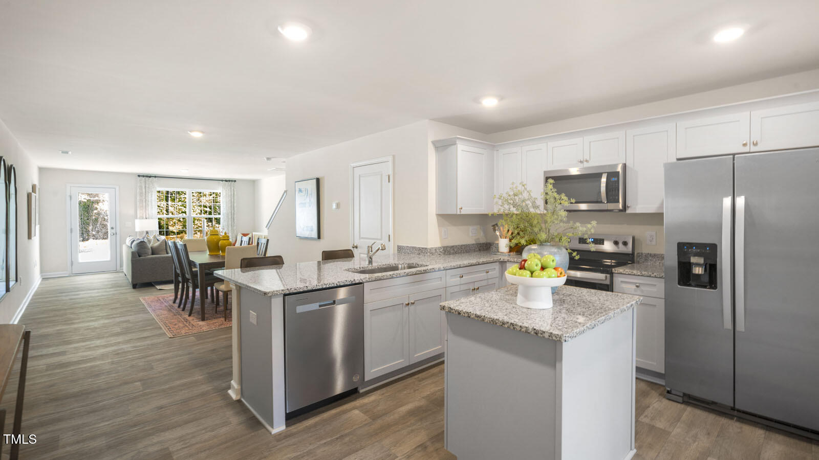 8537 Beckett Chase Way Raleigh, NC 27616 - Photo 7 of 32 a kitchen with appliances a sink cabinets and wooden floor