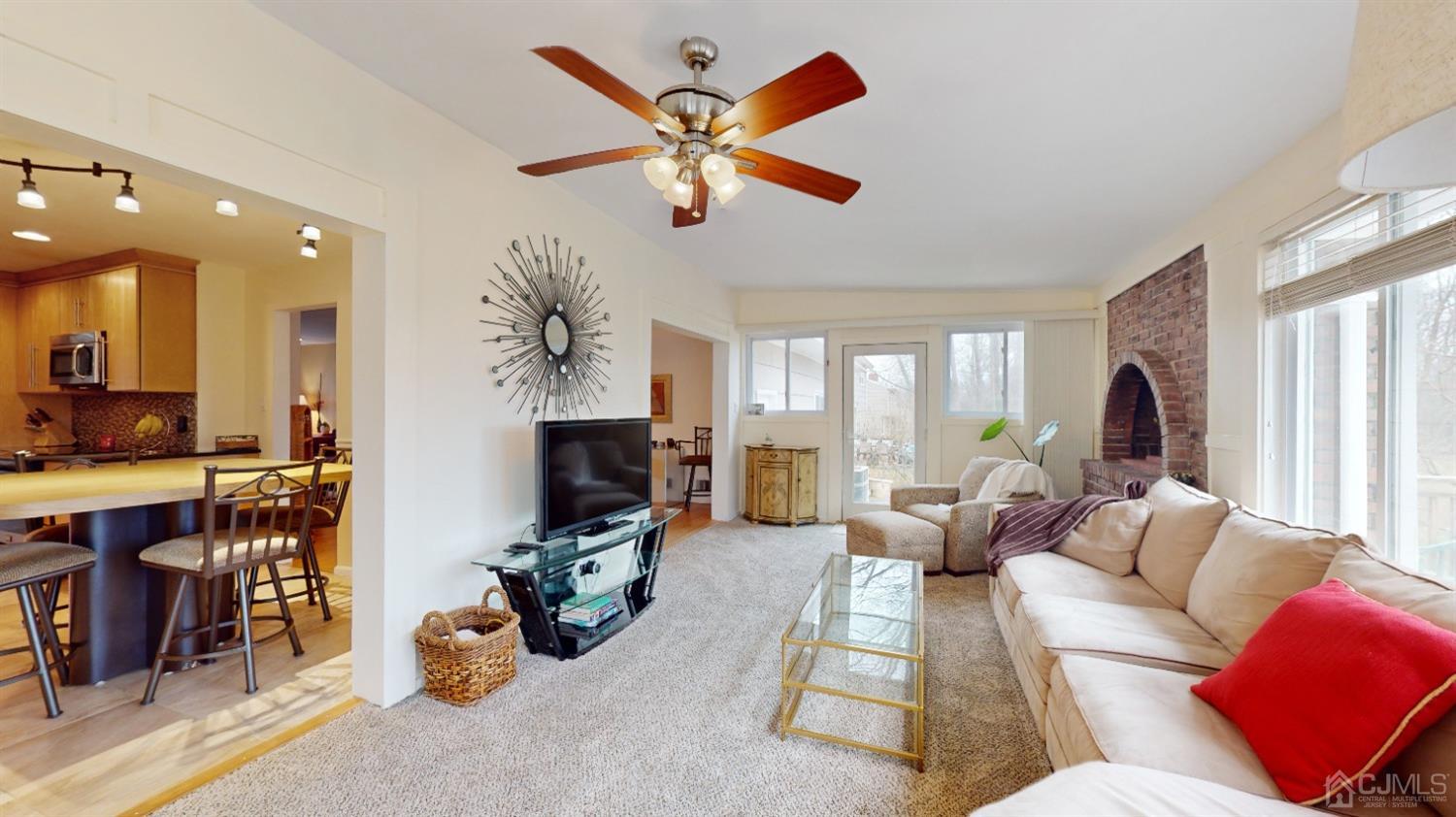 17 Timber Road Edison, NJ 08820 - Photo 5 of 37 a living room with furniture a fireplace and a chandelier