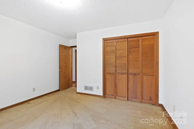an empty room with closet area