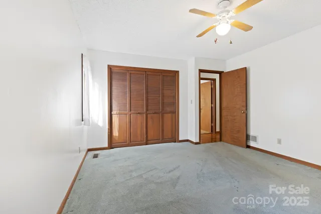 a view of an empty room with a fan