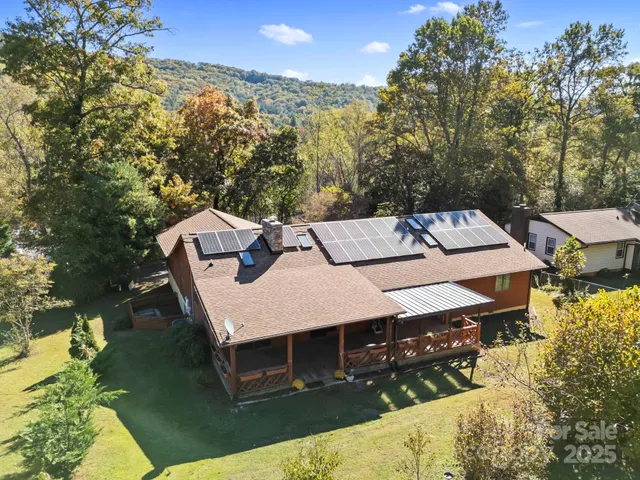 an aerial view of a house with a yard
