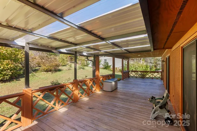 a view of a patio with chair and wooden floor